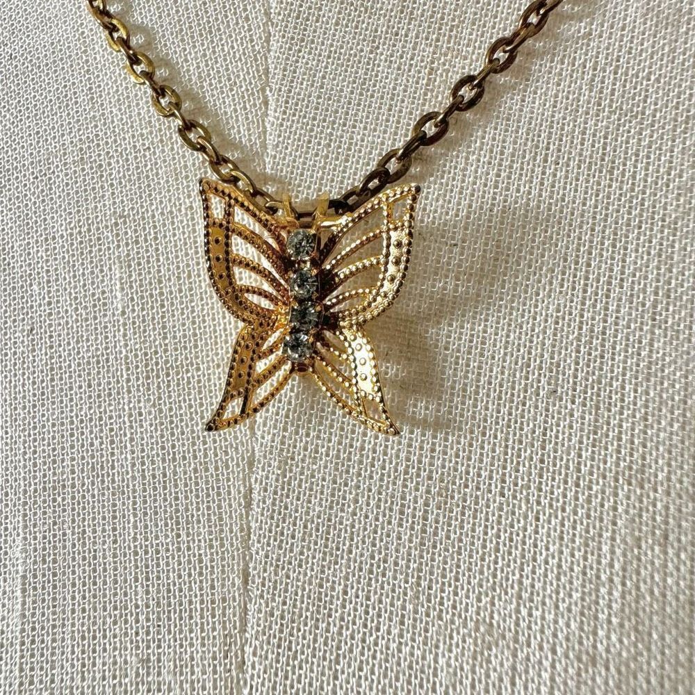 Gold tone and rhinestone butterfly pendant necklace